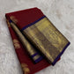 Folded maroon pure silk saree showing gold elephant motifs and oversized paisley border
