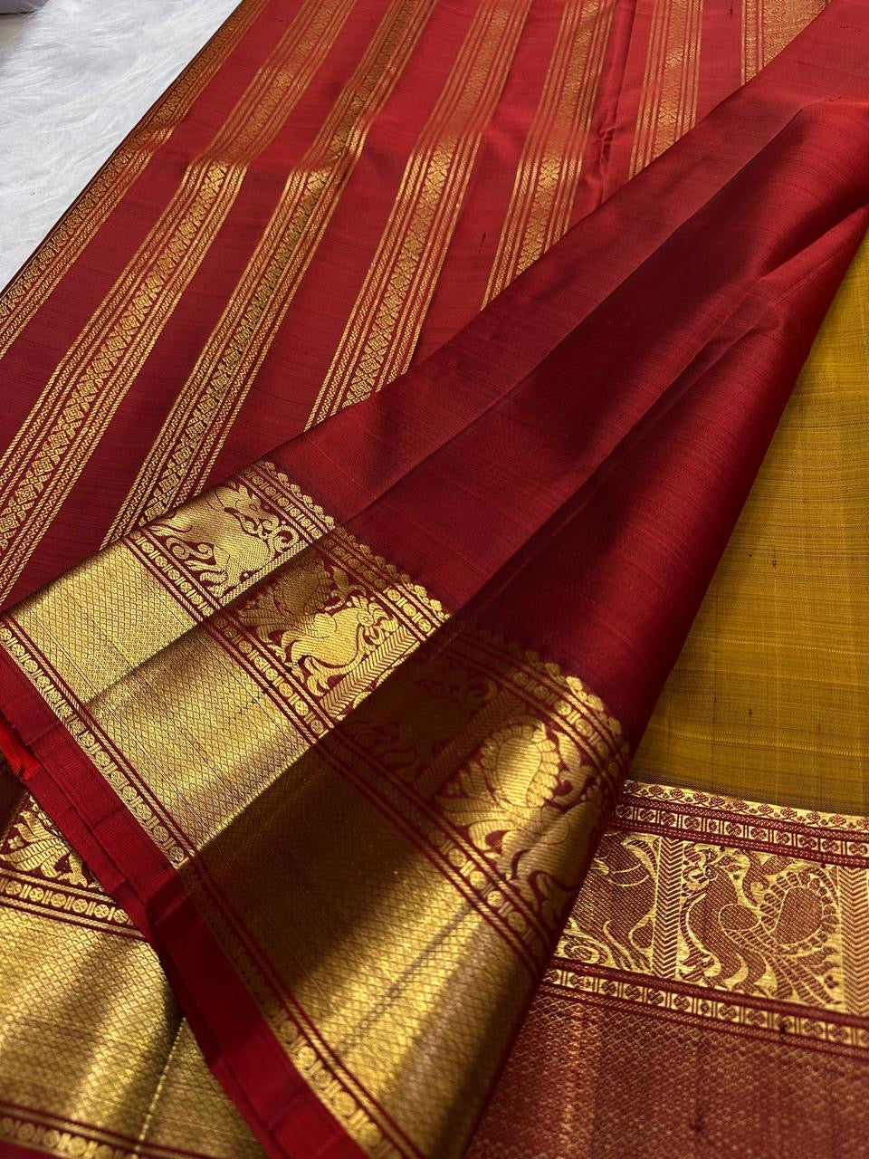 Broad zari border showing fine seer bands, mythic Yazhi forms and a dense diamond-kattam lower panel.