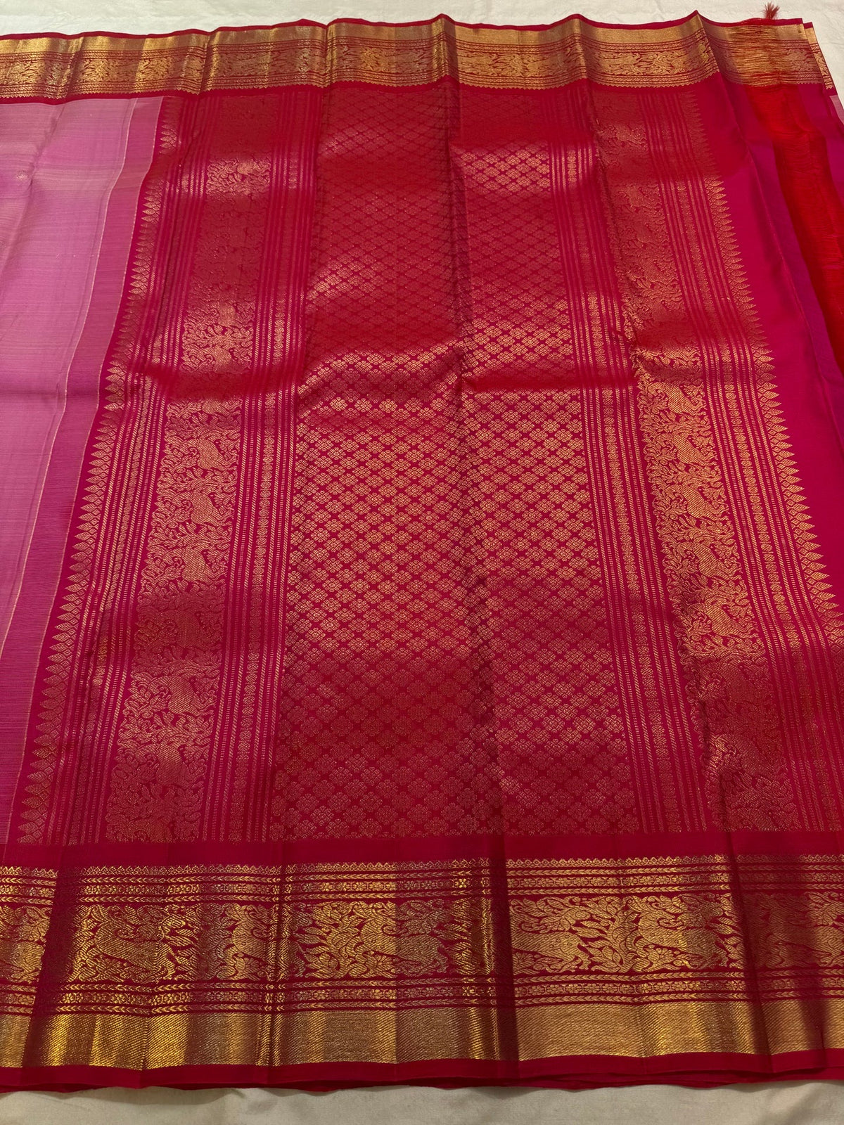 Deep Arakku-red Kanchipuram border with classic-gold zari, ornamental foliage and repeating stylised bird motifs