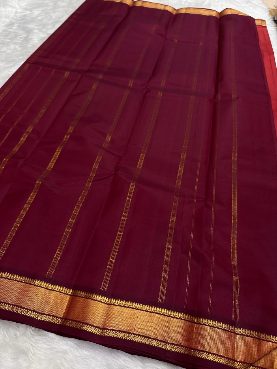 Brick Red and Deep Arakku Maroon lightweight Kanchipuram silk saree, broad gold zari border and striped maroon pallu; zari pattern