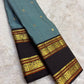 Handwoven ash blue Kanchipattu silk saree with cocoa brown korvai rettapet border and traditional gold zari Idam Living
