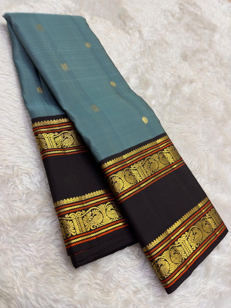 Handwoven ash blue Kanchipattu silk saree with cocoa brown korvai rettapet border and traditional gold zari Idam Living