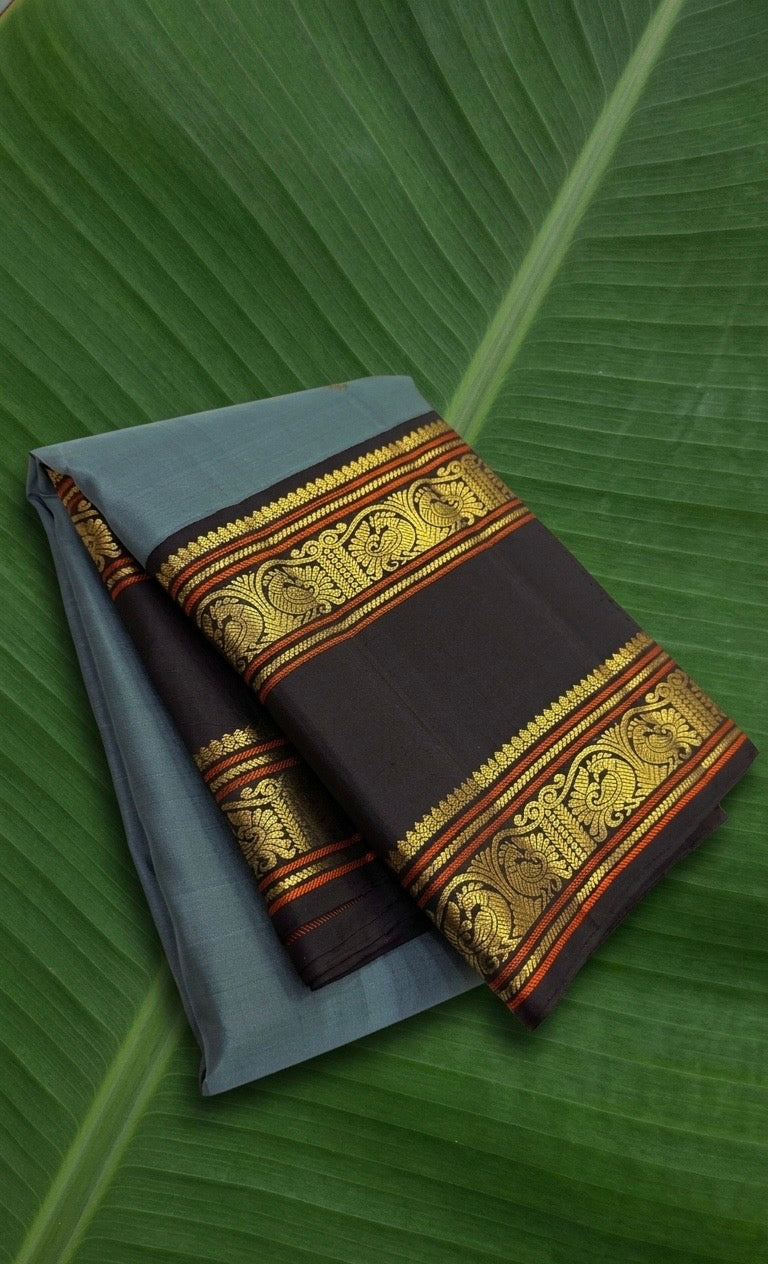 Ash blue Kanchipuram silk saree with cocoa brown korvai rettapet border and gold zari motifs on banana leaf Idam Living