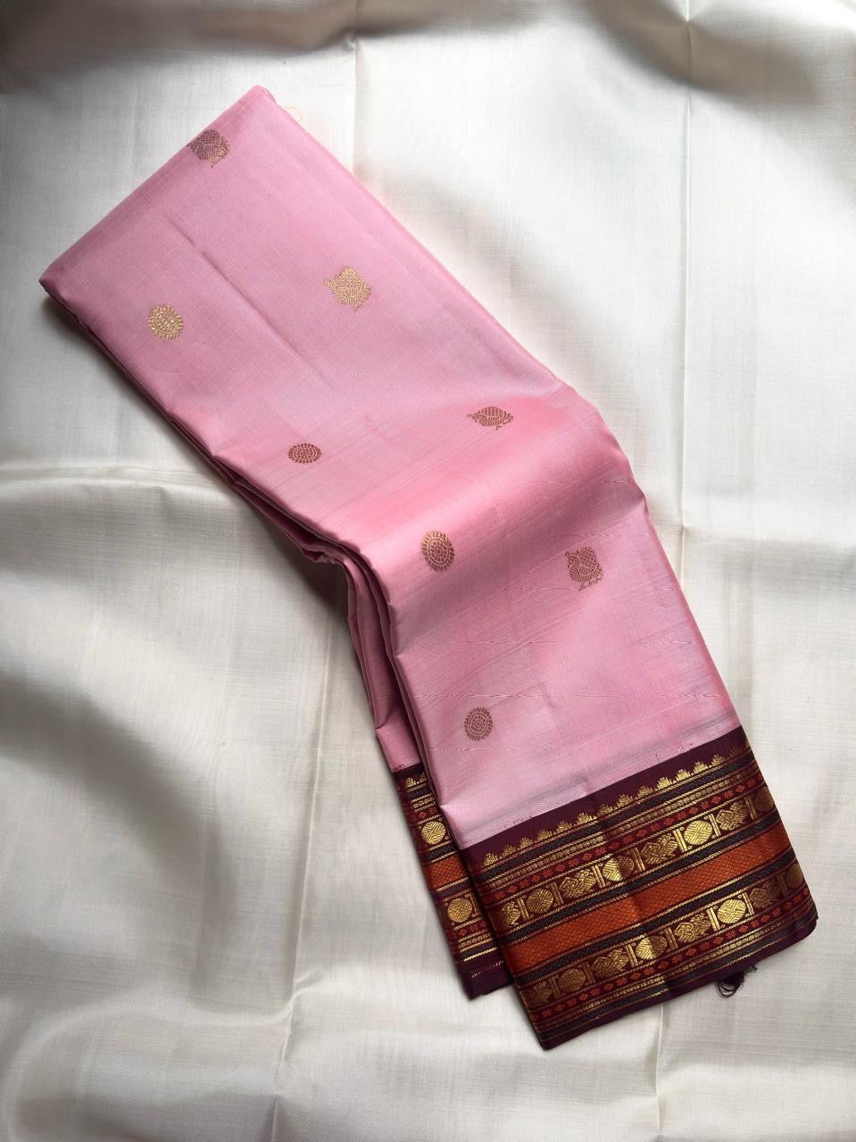 Deep Aubergine Kanchipuram Korvai pallu densely woven with gold zari geometric fields and ornamental registers.