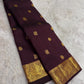 Handwoven Kanjeevaram silk saree featuring traditional gold buttas across a deep cocoa brown body