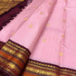 Close view of deep Aubergine Korvai border and pallu with antique-gold zari and warm copper ornamental bands.