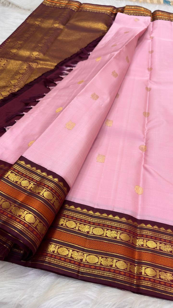 Close view of deep Aubergine Korvai border and pallu with antique-gold zari and warm copper ornamental bands.