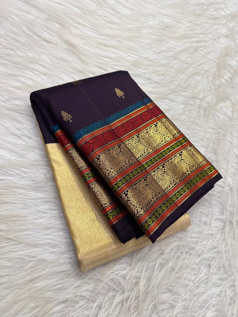 Handwoven Annapakshi zari buttas on aubergine Kanchipuram tissue silk
