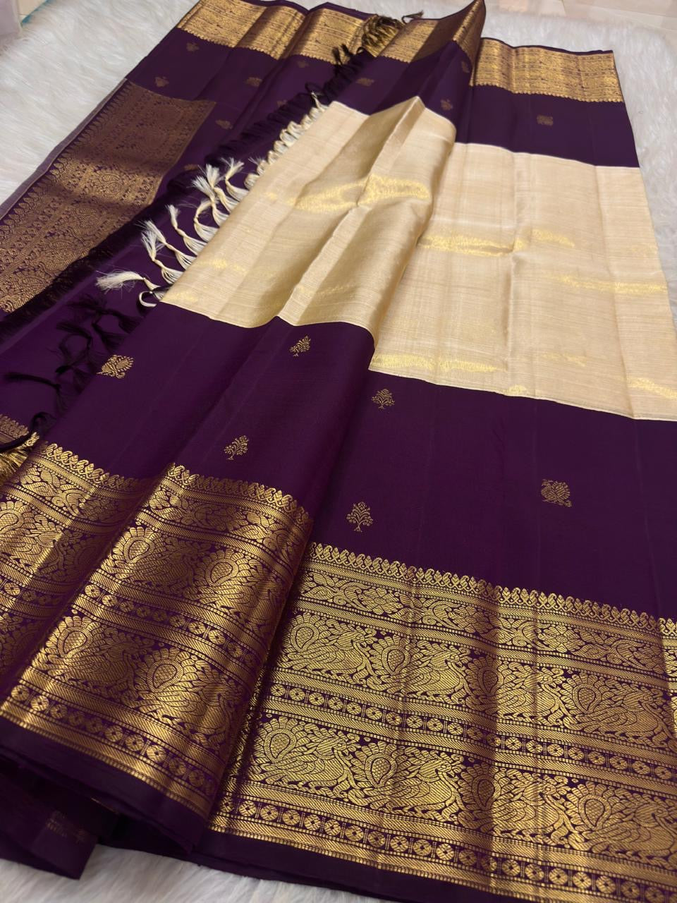 Deep Aubergine Purple Kanchipuram silk with floral and leaf zari buttas.