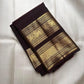 Close-up of gold zari buttas on Aubergine Kanjivaram silk saree body