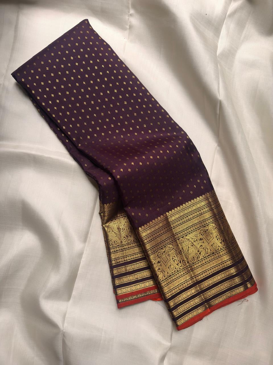 Deep Aubergine Purple pure silk Kanchipuram saree with antique-gold woven detailing.