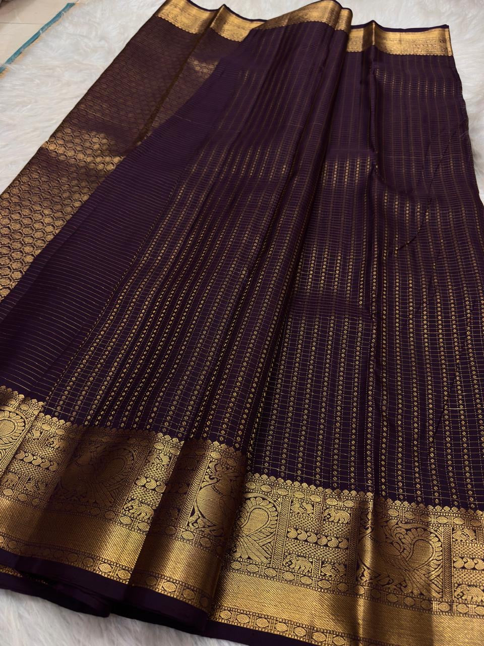 Aubergine Purple pure silk Kanchipuram saree with antique-gold woven detailing.