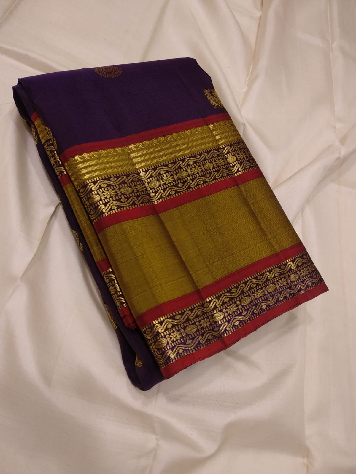Folded view of aubergine purple and ponvandu muted yellow rettapet korvai Kanchipuram silk saree — Idam Living