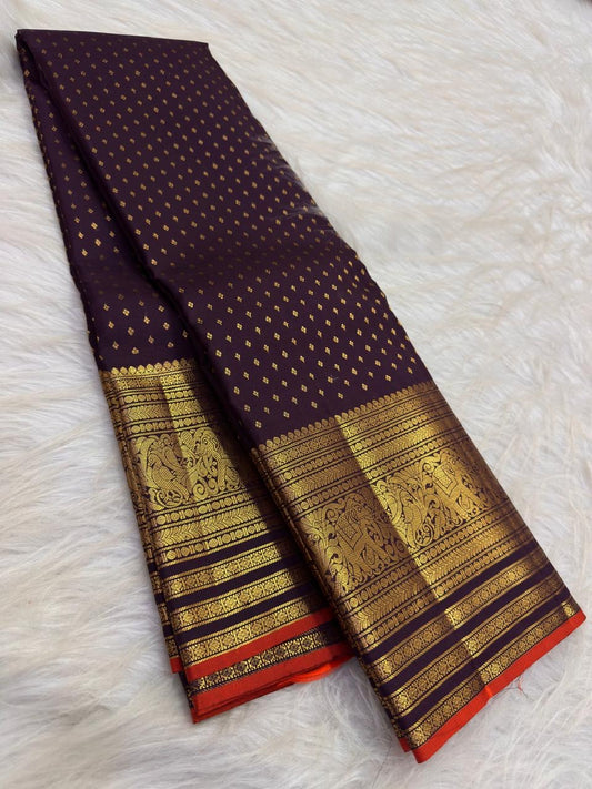 Close view of antique-gold traditional zari border on Deep Brown silk with purple Kanchana undertone.