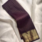 Antique-gold zari lines woven across Aubergine Purple Kanjivaram silk body.