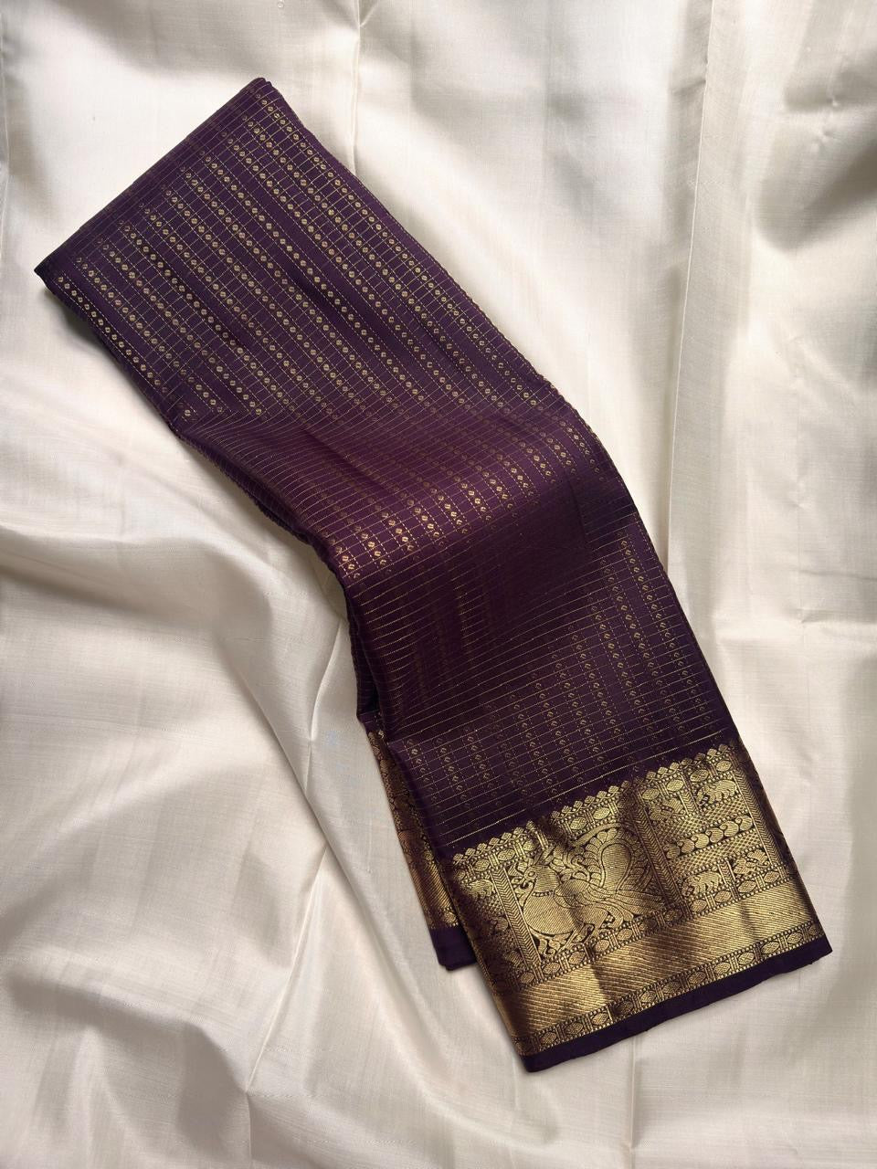 Antique-gold zari lines woven across Aubergine Purple Kanjivaram silk body.