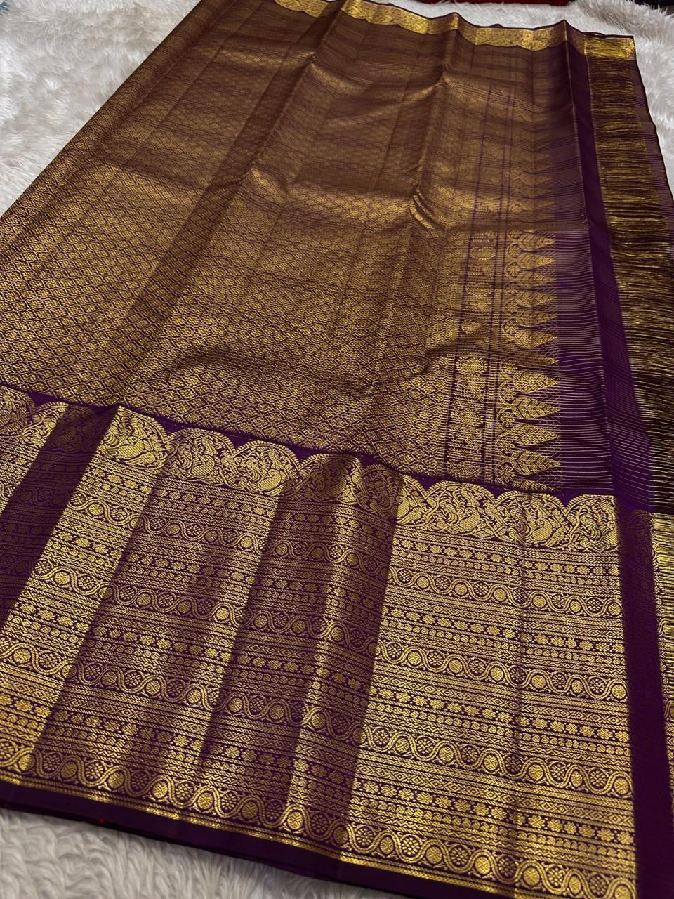 Close view of Deep Aubergine Purple Kanchipuram Zari Kattam silk with antique-gold ornate border and richly woven pallu.
