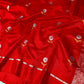 Vermilion red Pattu silk Chanderi saree showing floral buta motifs across the body with metallic-toned striped border