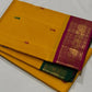 Mustard yellow Kanchipuram silk saree with contrasting bottle green and magenta Korvai borders and gold zari bands