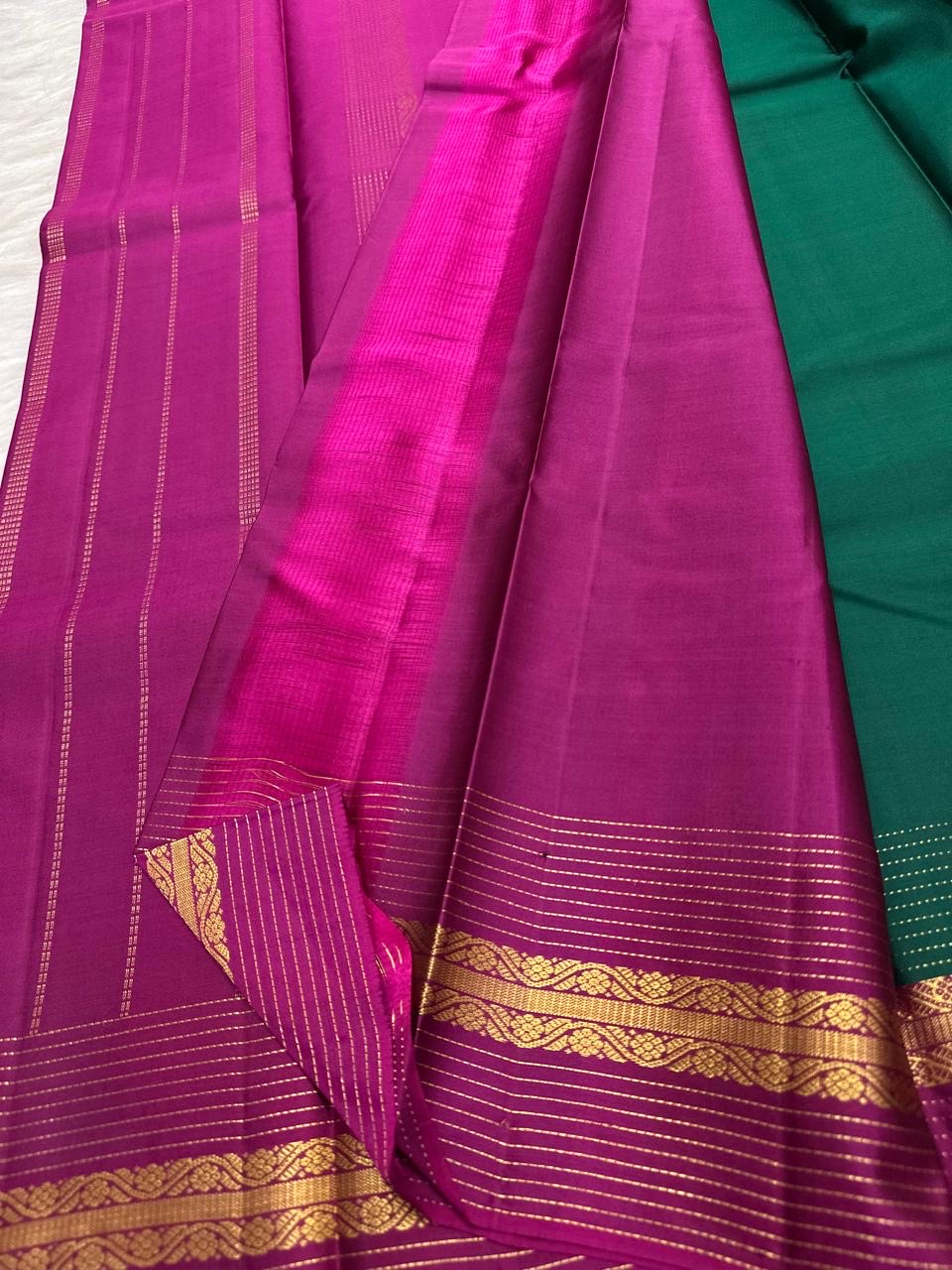Emerald Green and Vadamalli Magenta lightweight Kanchipuram silk saree, spaced buttas and scrolling floral zari border; body detail