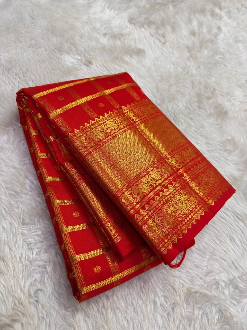 Vermilion Red Gold Checks pure silk Kanchipuram saree, woven buttas, showing brilliant kumkum red, warm vermilion orange highlights and glowing yellow-gold zari