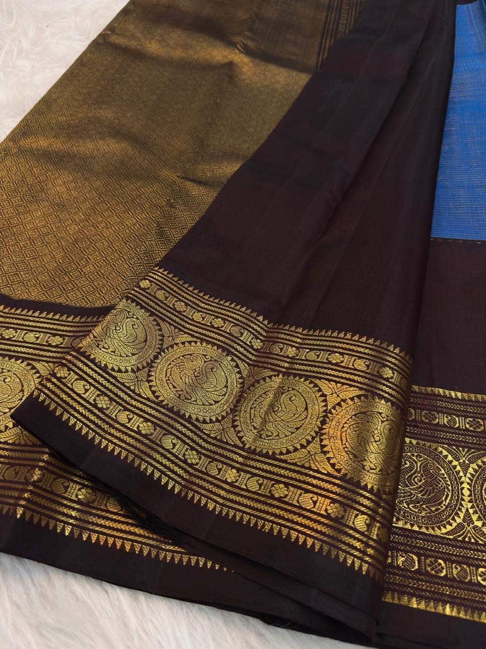 Grand Mayil peacock border on Azure Blue and Kanchana Brown Kanjivaram saree.