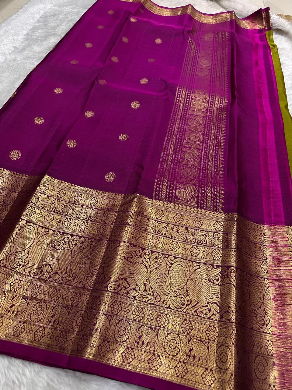 Traditional Kanchipuram saree in olive moss green with temple-inspired Yazhi motif zari border