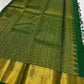 Broad gold zari border with textured field on the emerald green saree.