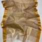 Close-up of Sandalwood Beige Katan Silk Chanderi saree showing petite gold buttas with vermilion-red accents.
