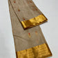 Sandalwood Beige Chanderi silk saree with scattered gold and vermilion buttas, gold border and broad floral pallu.