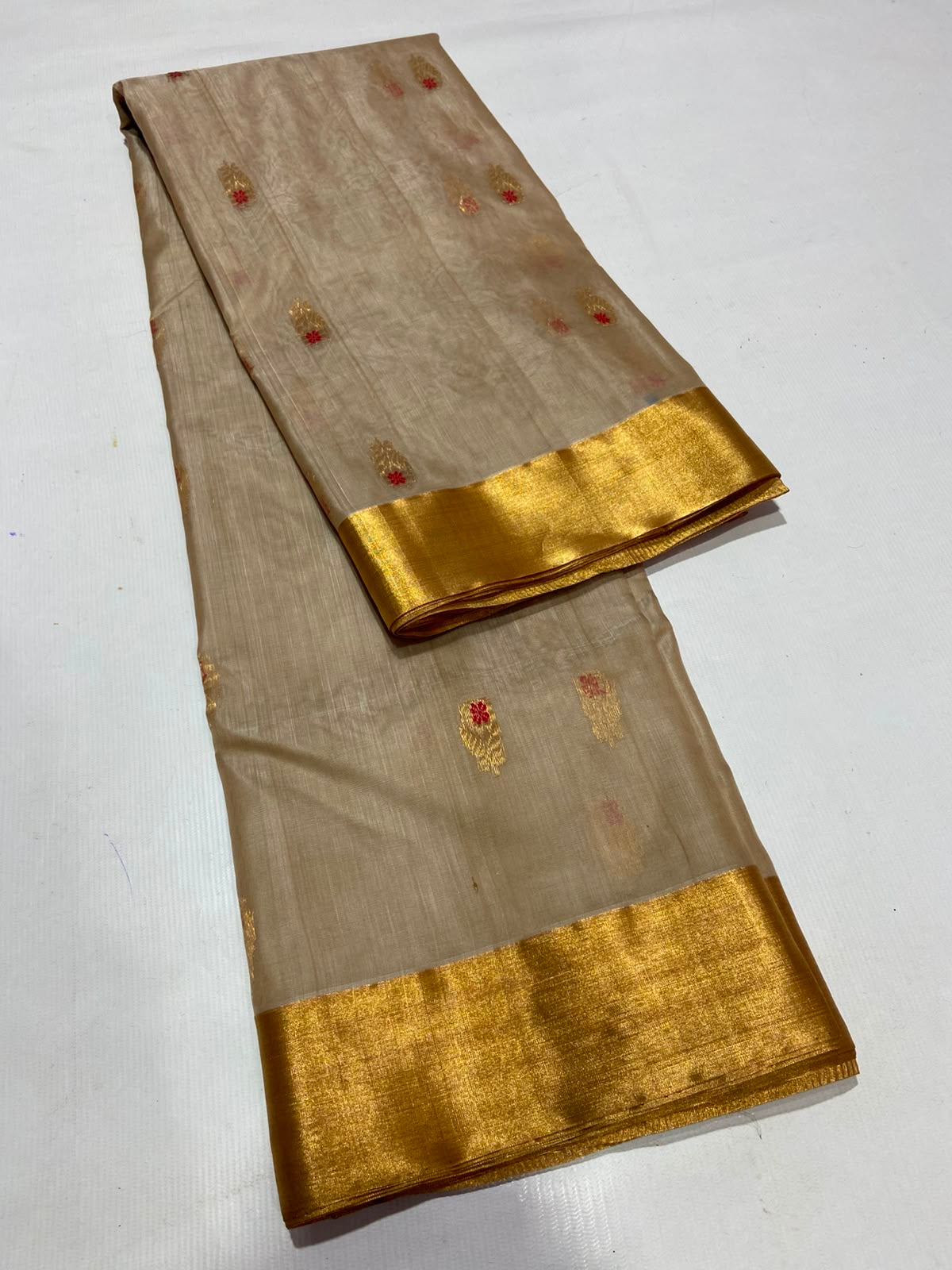 Sandalwood Beige Chanderi silk saree with scattered gold and vermilion buttas, gold border and broad floral pallu.