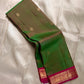 Olive green pure Kanchipuram silk saree shown folded with small gold buttas and a magenta zari woven border.