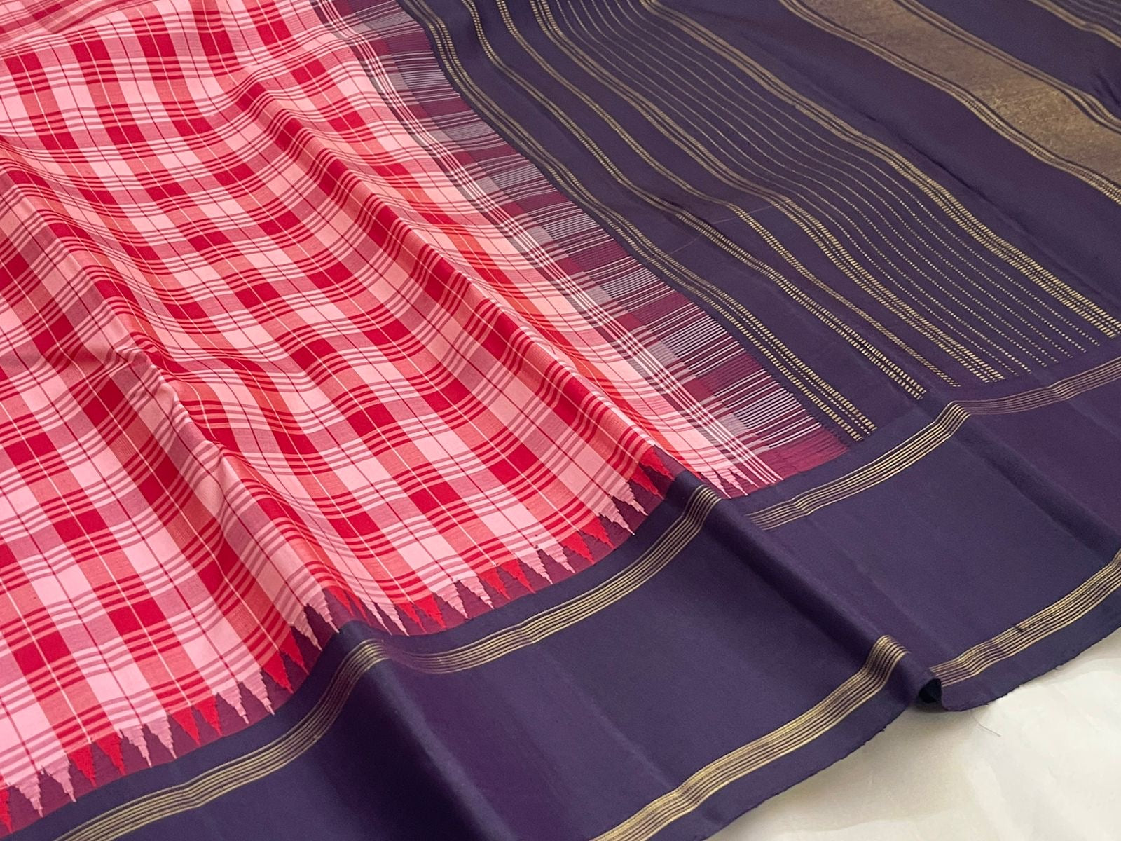 Berry kattam and deep navy Kanjivaram silk saree folded showing multicolour check body and contrast navy Rettapet border