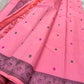 Pink pure Kanchipuram silk saree laid out with dark paisley pallu panel, tassels, and contrasting woven border