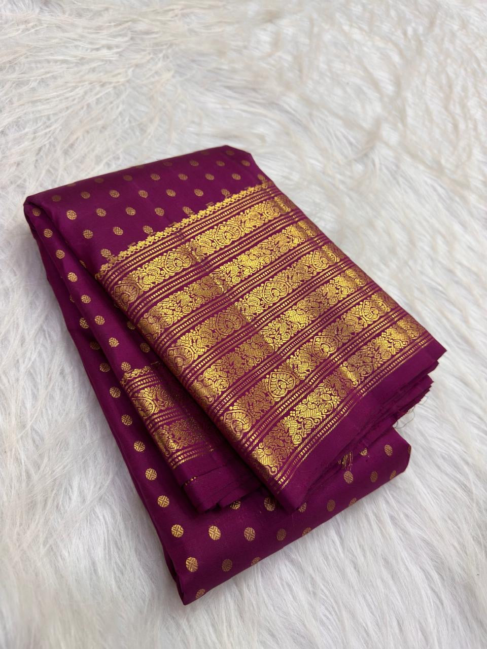 Handwoven pure silk Kanchipuram butta saree in deep brown with round gold zari buttas and a Varisaipet border.