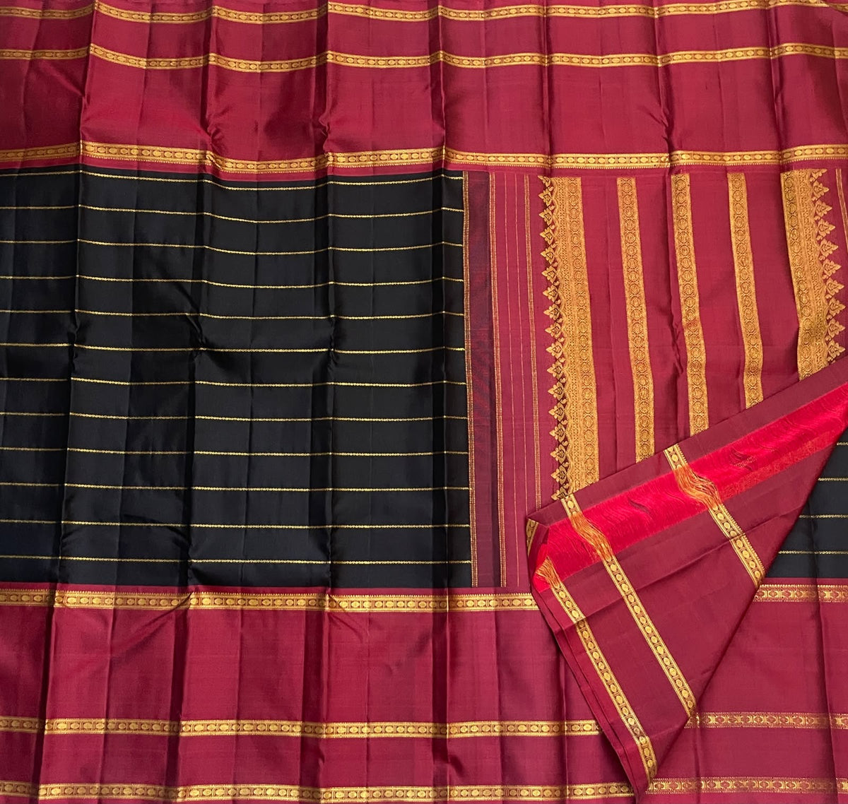 Close view of fine Veldhari zari lines running along deep black Kanjipuram silk