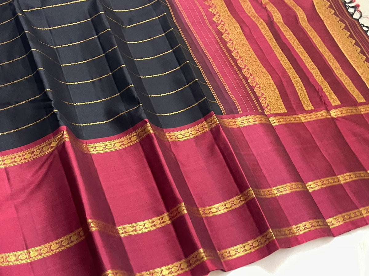Rettapet border in Arakku red with repeated traditional gold zari bands on black silk