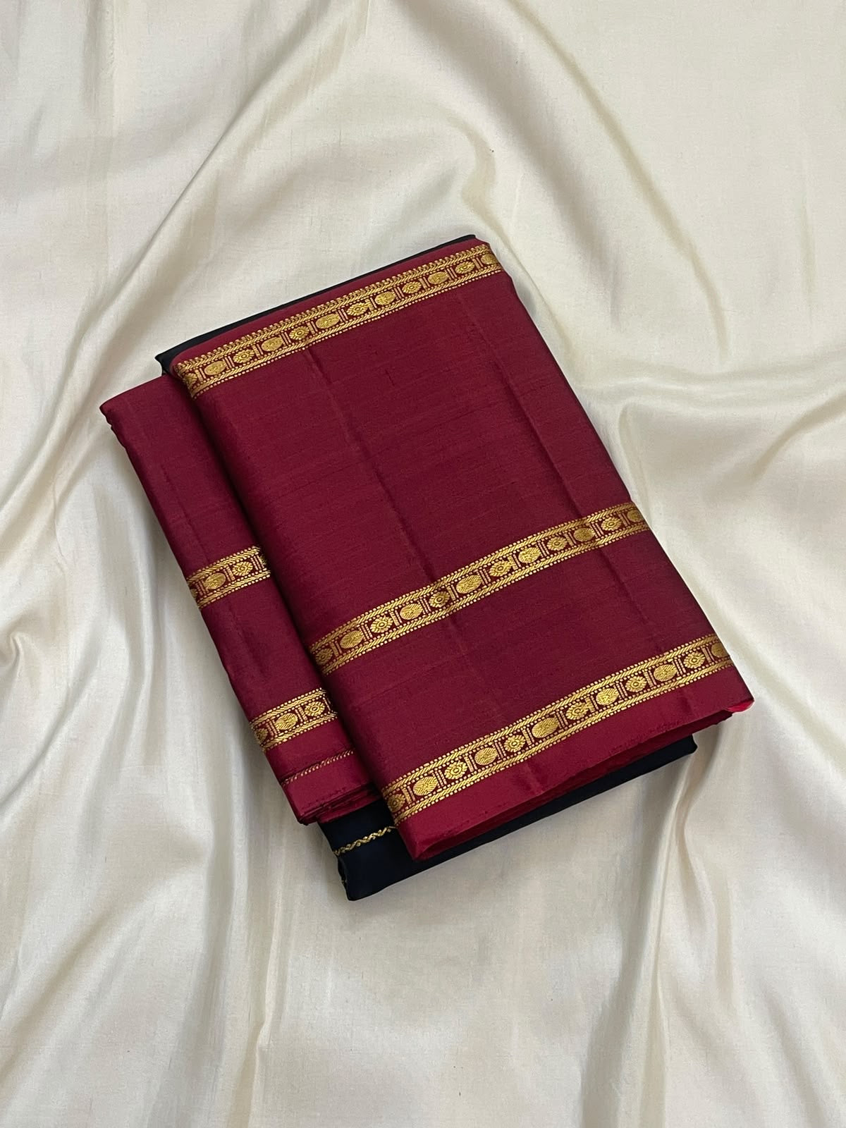 Deep black Kanjipuram silk with fine lengthwise gold Veldhari lines and Arakku red border
