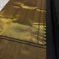 Close view of broad antique-gold geometric zari border on Midnight Black Kanjivaram silk.