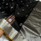 Small silver-toned woven motifs on deep black silk