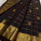 Black kanchipuram silk saree spread with gold zari check pattern and gold border, available in the USA