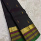 Black pure silk Kanchipuram saree with green pink striped border.