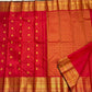 Grand precise grid pallu in dense gold zari on a kumkum red Kanchipuram silk saree