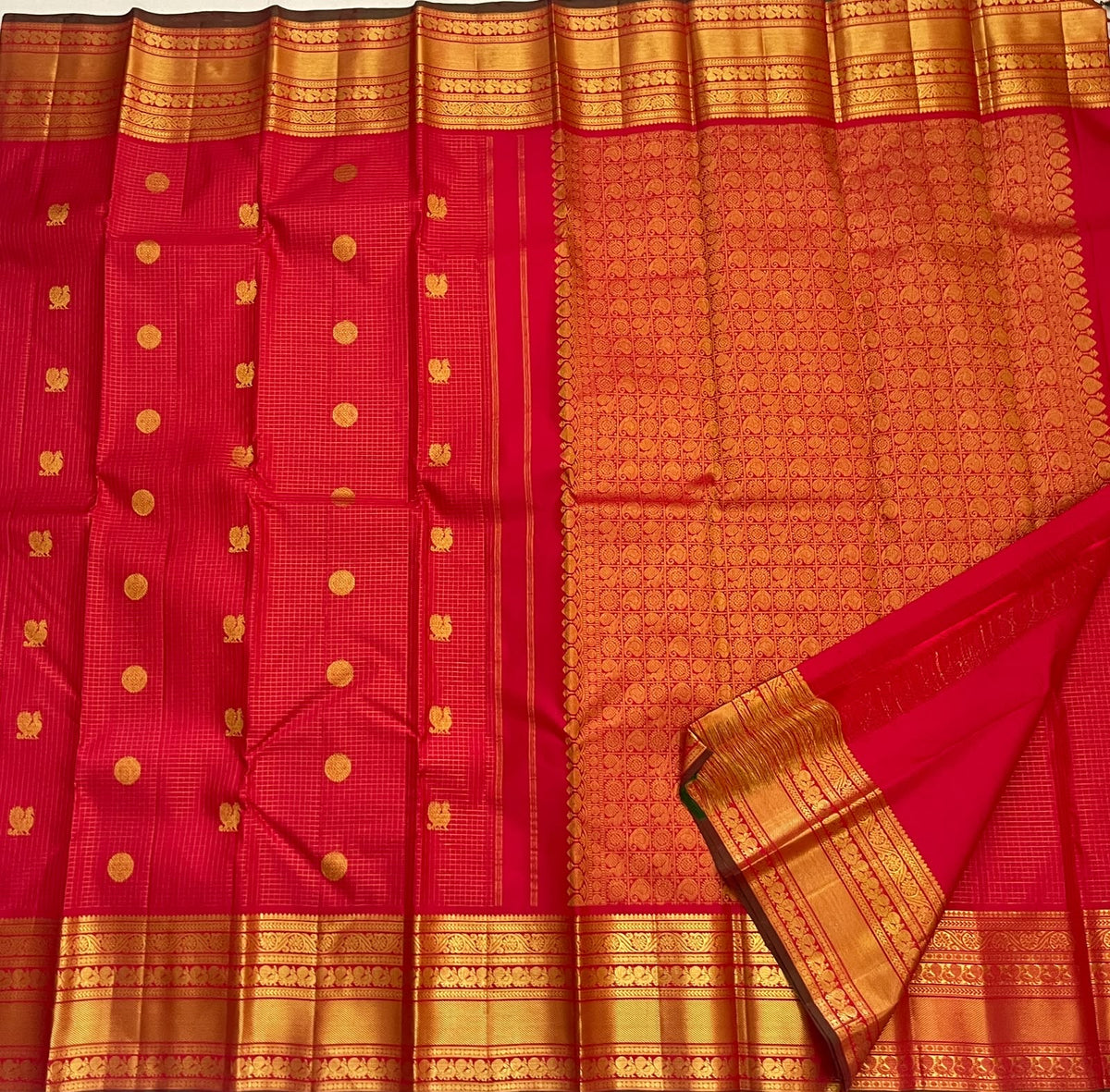 Grand precise grid pallu in dense gold zari on a kumkum red Kanchipuram silk saree