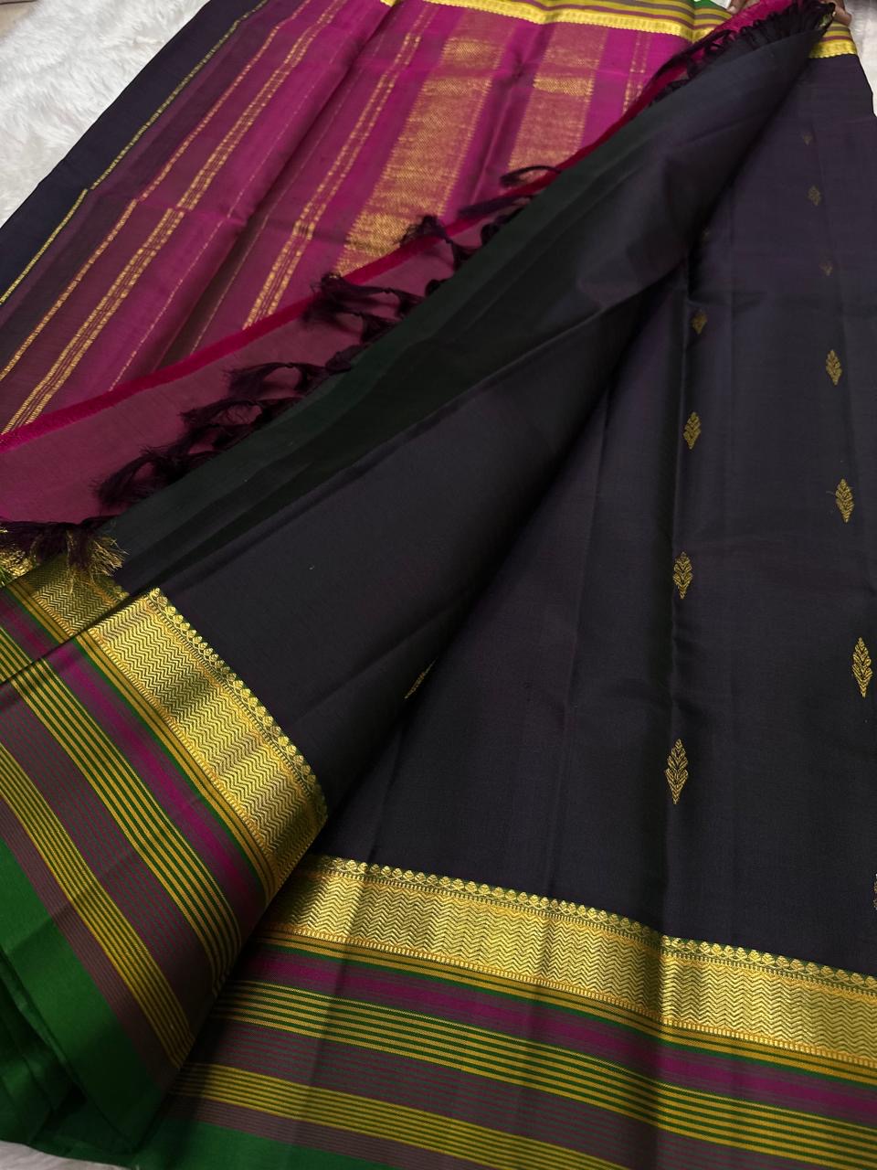 Lightweight black Kanjivaram with traditional gold buttas.