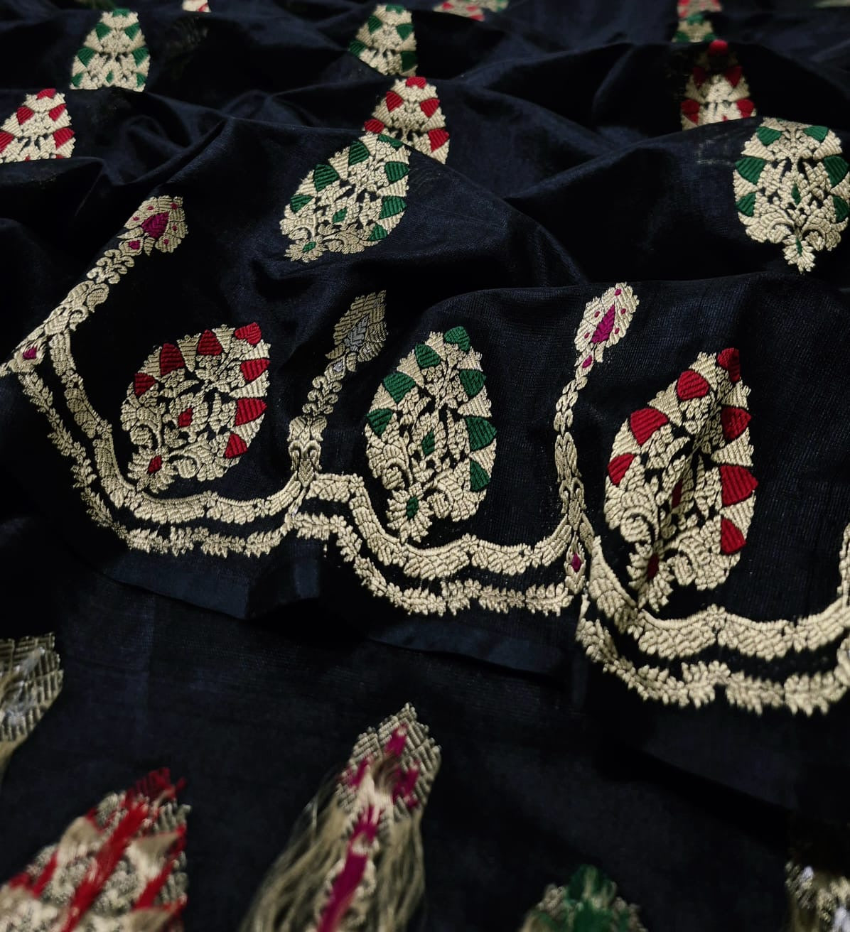 Close view of black Chanderi silk saree with ornamental gold-toned border and multicolour woven details