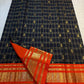 Black, burnt-orange and classic-gold Kanchipuram silk arranged to show checked body, border and rich pallu.