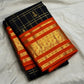 Handwoven black Pure Silk Kanchipuram Zari Kattam saree with burnt-orange and classic-gold contrast.