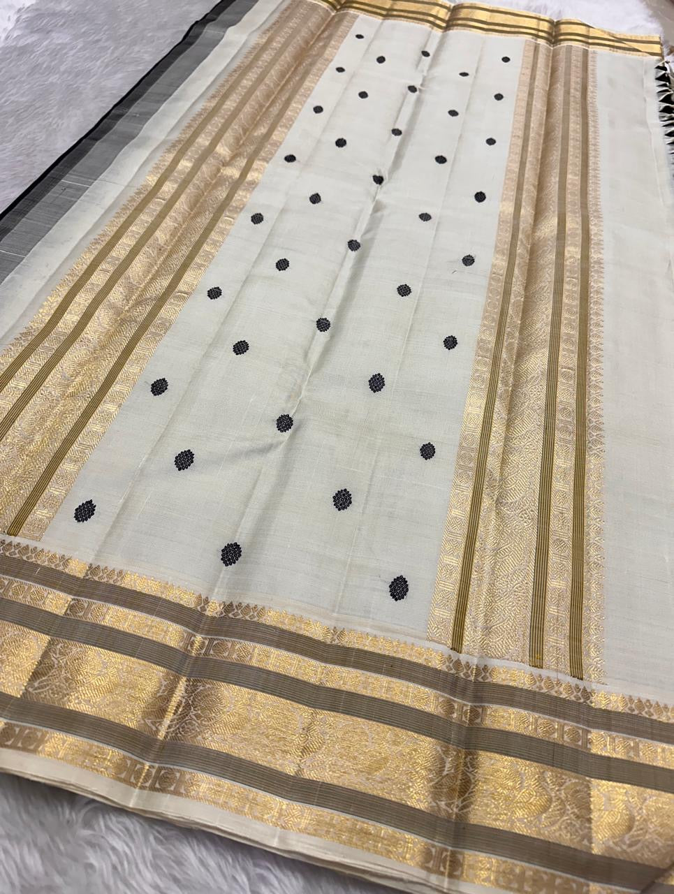 Black Kanchi pattu saree ivory butta gold zari korvai border folded saree detail