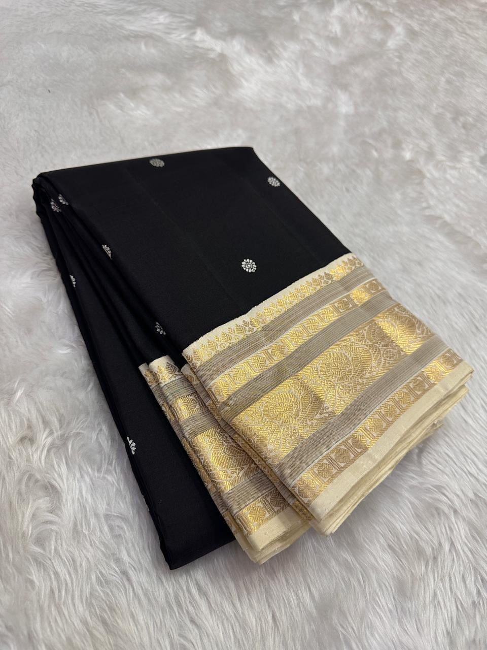 Black Kanchipuram silk saree with ivory buttas and antique gold zari border korvai weave folded view
